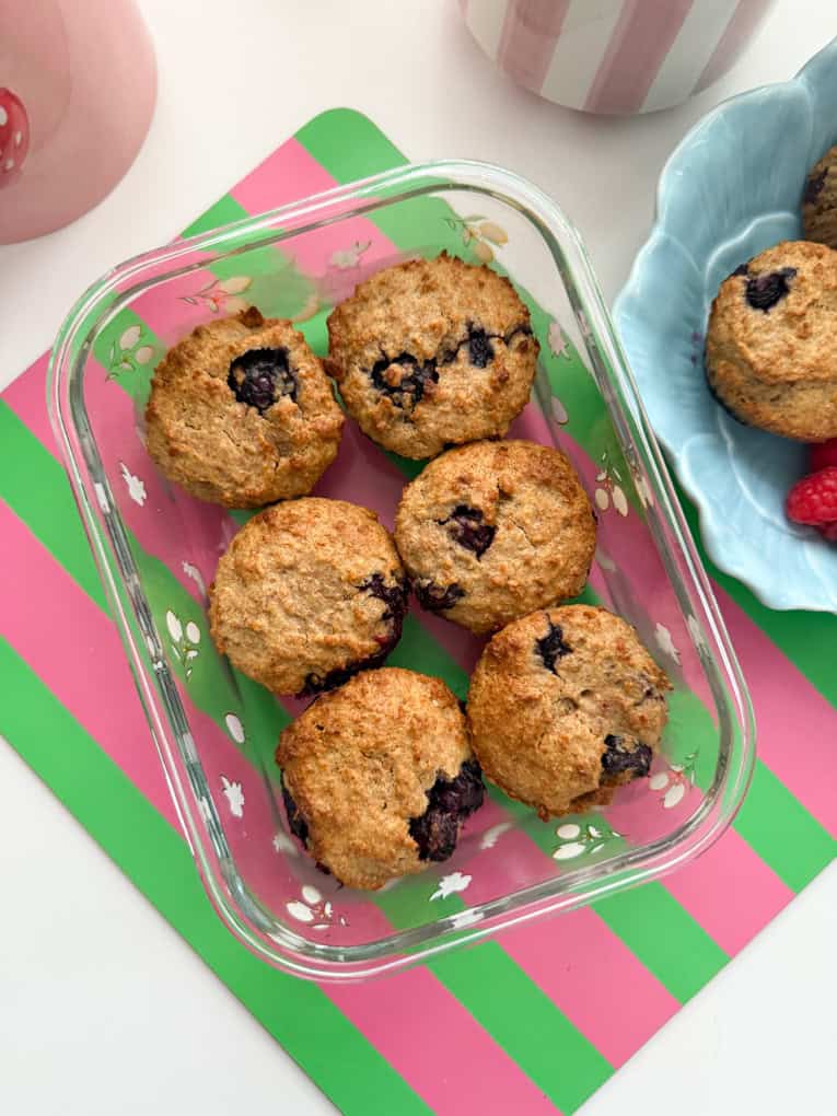 Six muffins served in a glass dish.