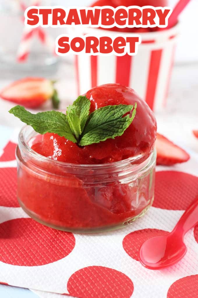 Two scoops of strawberry sorbet served in a small glass ramekin with a sprig of fresh mint.