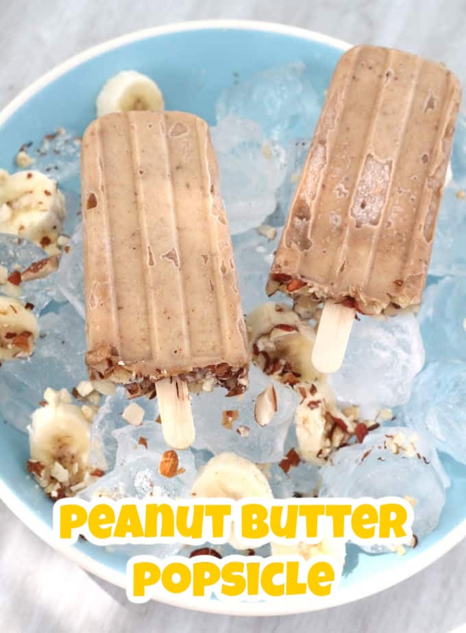 Two Peanut Butter Popsicles sitting on top of ice cubes in a blue bowl.