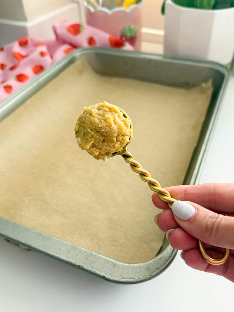 Chicken meatballs arrange on a baking tray on parchment paper.