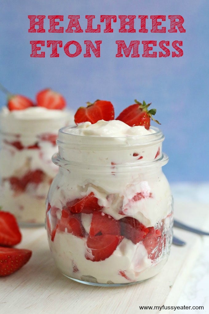 Healthier Eton Mess served in a glass mason jar, topped with fresh strawberries