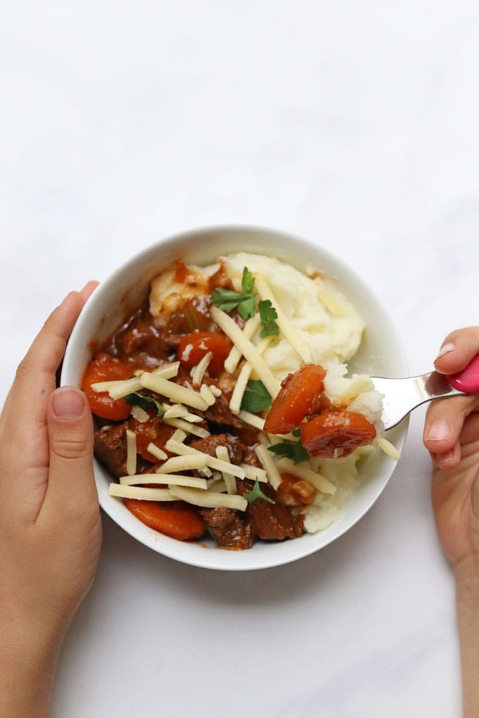 beef casserole served with mashed potato and cheese