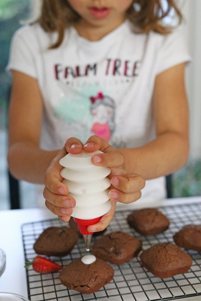 child decorating brownies