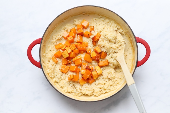 cooked butternut squash added to the cooked risotto mixture in the oven proof dish