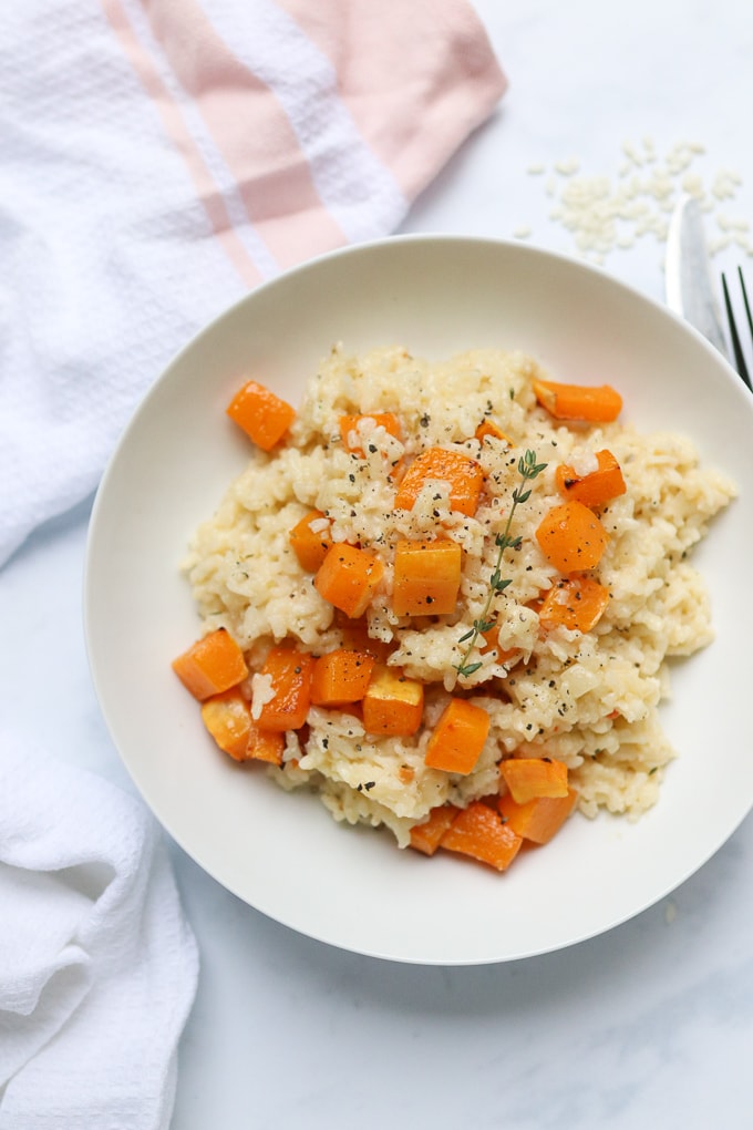 baked butternut squash risotto served in a white bowl