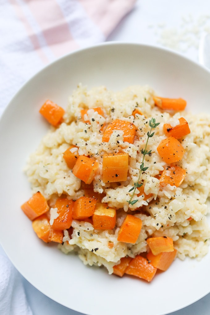 close up of the finished baked butternut squash risotto served in a white bowl