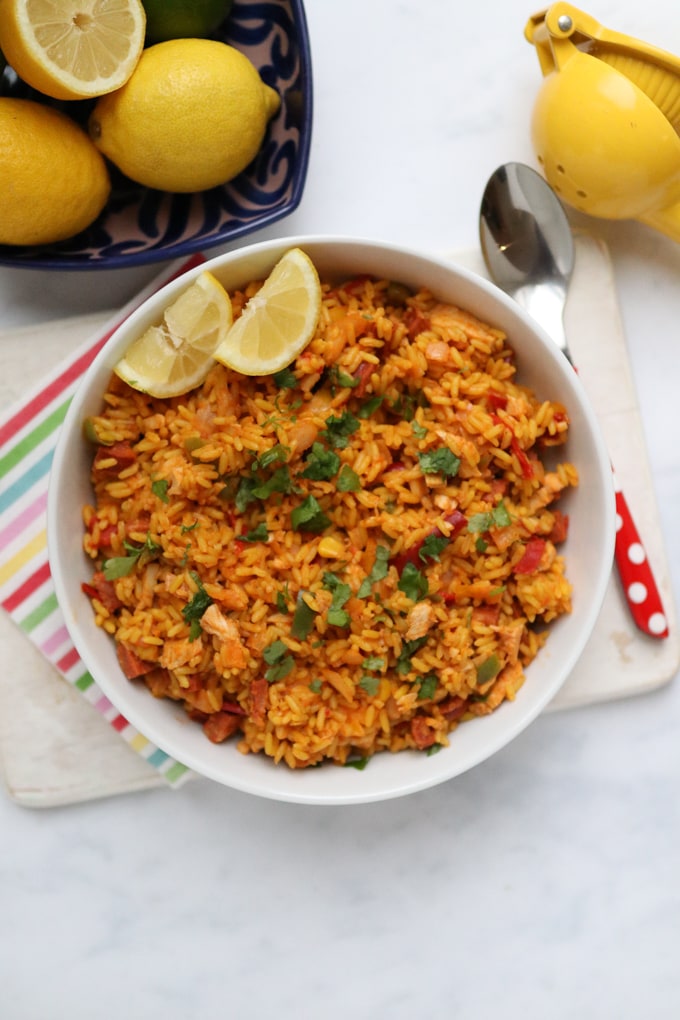 Cheat's Paella in a bowl with 2 lemon segments