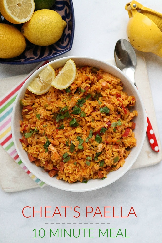 Cheats paella served in a white bowl and garnished with two slices of lemon.