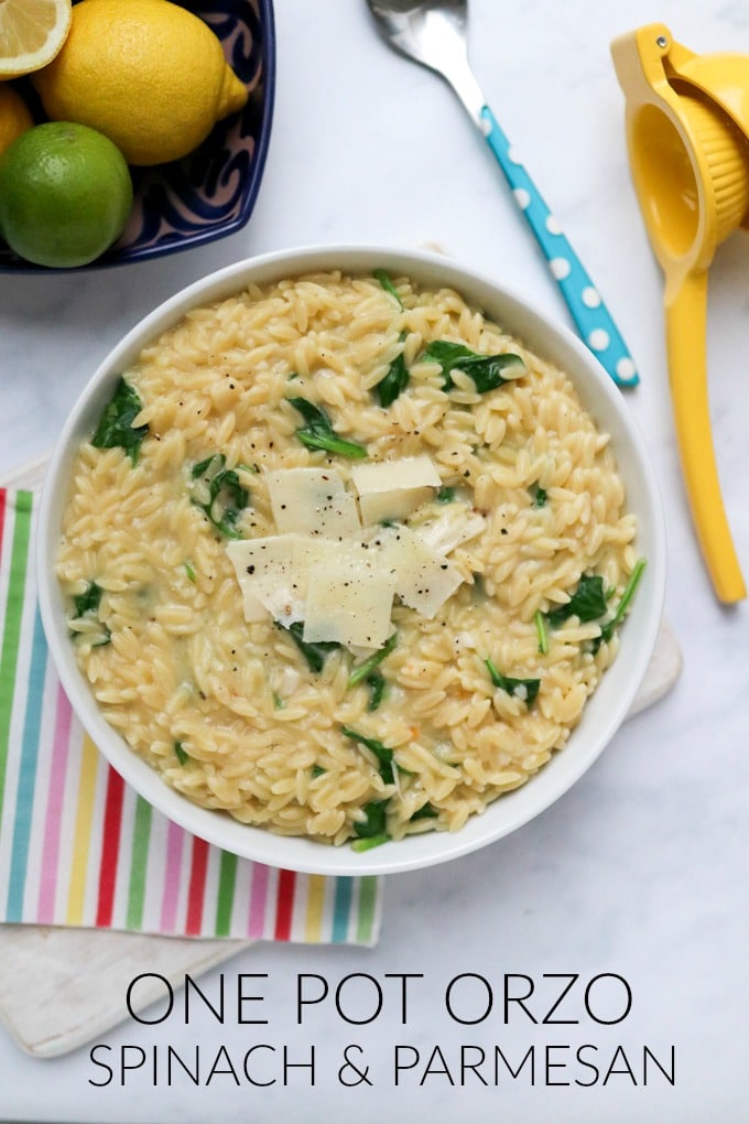 Spinach & Parmesan Orzo served in a white bowl and garnished with parmesan shavings