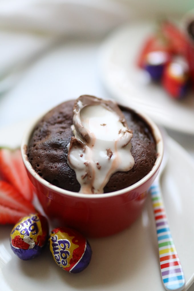 The Creme Egg Mug Cake cooked and topped with half a mini creme egg.