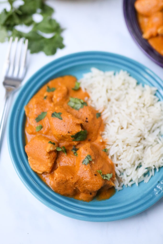 hidden veg chicken curry with rice on a blue plate