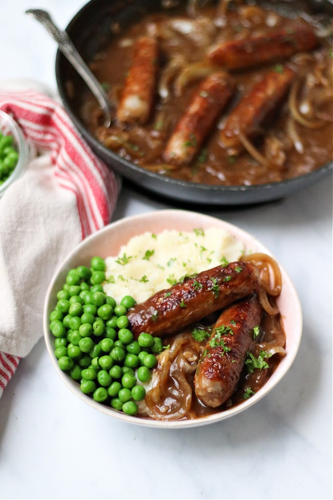 Sausages in Onion Gravy served with mash and peas