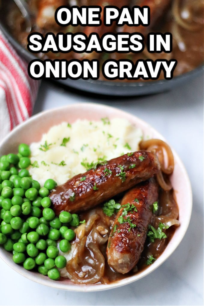 Sausages in Onion Gravy served in a bowl with mashed potato and green peas.