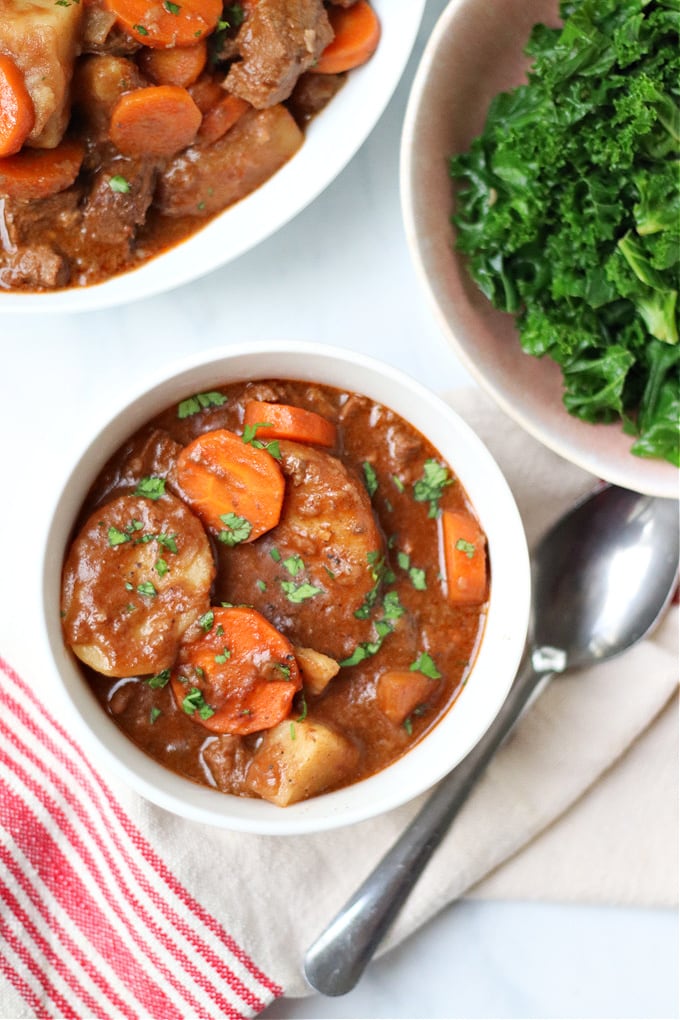 beef stew served with a side serving of greens