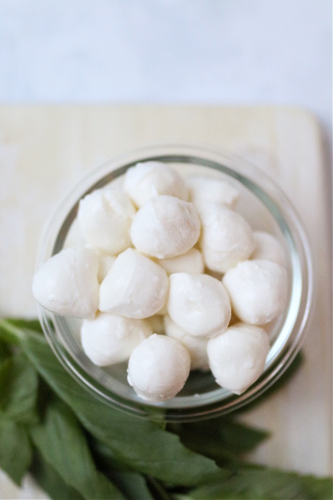 a small bowl of mini mozzarella balls