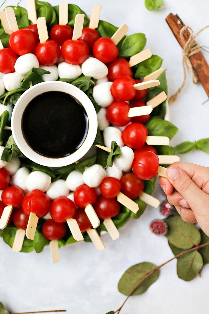 Caprese Christmas wreath with a bowl of balsamic glaze in the middle