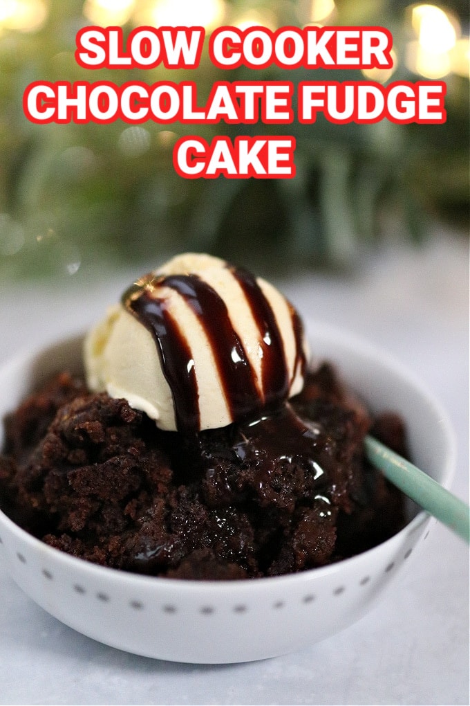 Slow Cooker Chocolate Fudge Cake in a white bowl served with a dollop of vanilla ice cream on top and fidge sauce.