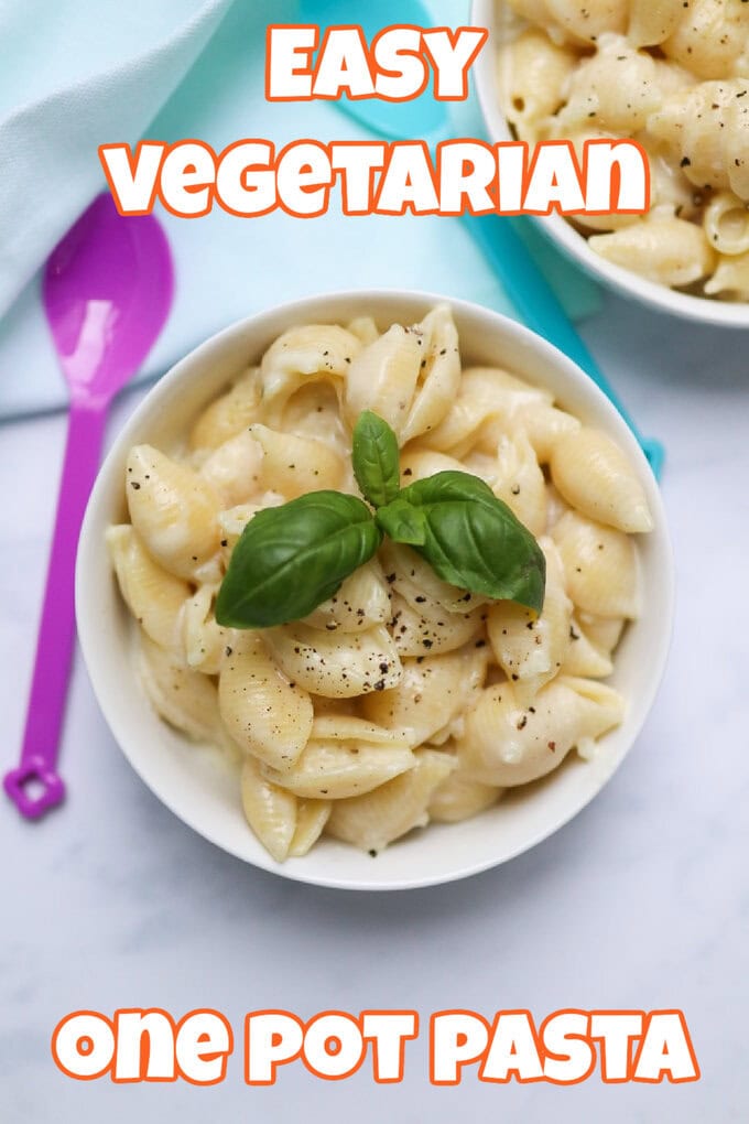 Easy Vegetarian One Pot Pasta served in a white ceramic bowl topped with a sprig of fresh basil leaves and black pepper.