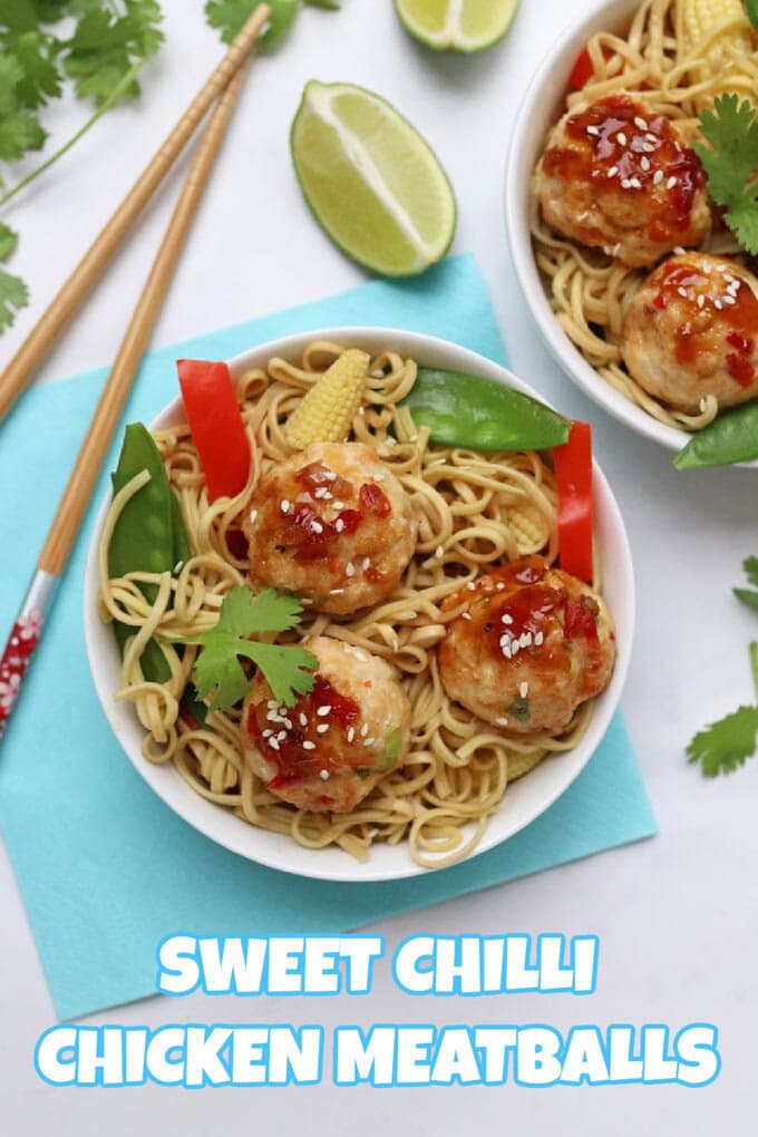 Sweet Chilli Chicken Meatballs in a white bowl with egg noodles, mange tout, mini sweetcorn and sliced red pepper. Sat on top of a light blue napkin with a set of chopsticks to the left side.