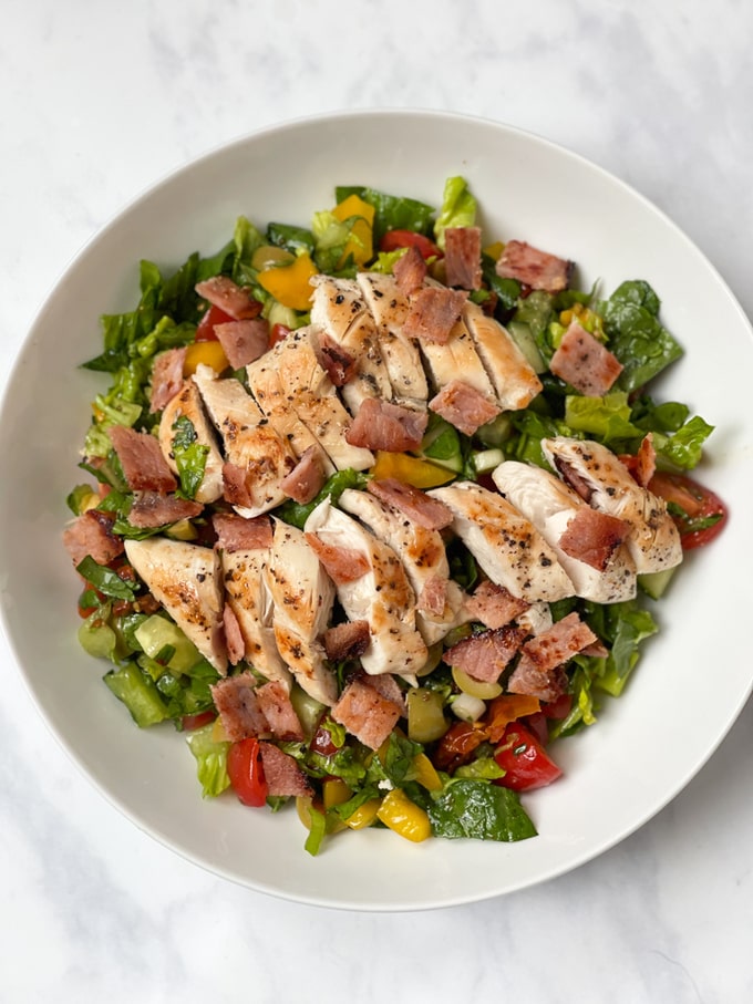 chicken & bacon salad served in a white bowl