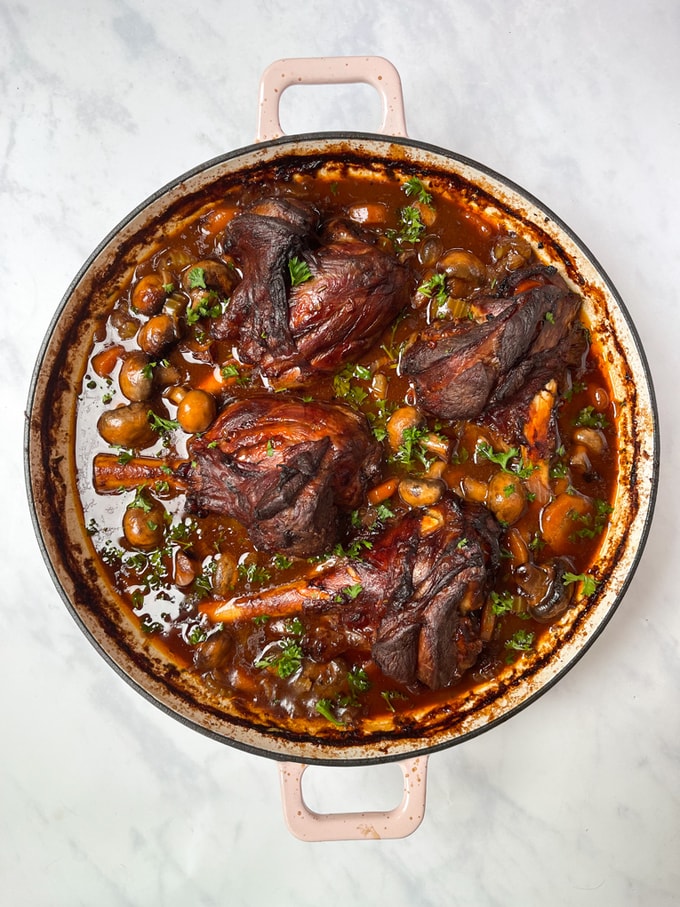 lamb shank casserole in a large round ovenproof casserole dish