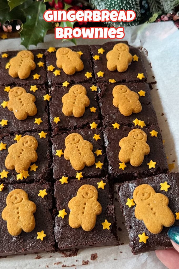 Gingerbread Brownie squares on white parchment paper decorated with mini gingerbread men and mini edible gold stars