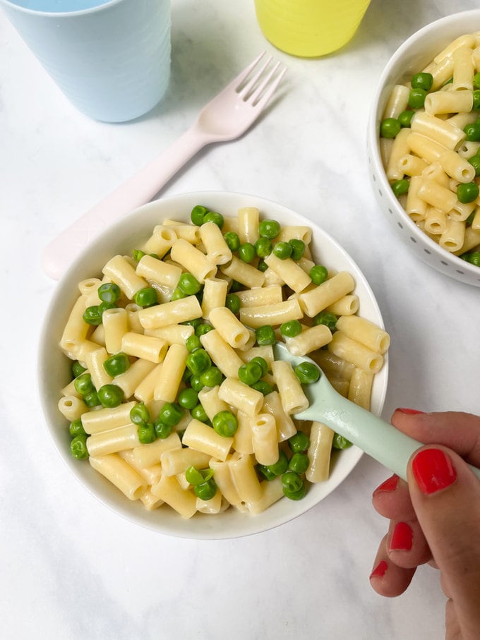 Three ingredient cheesy pea pasta served in a bowl.