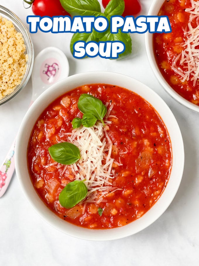 Tomato & Pasta Soup garnished with some finely grated parmesan cheese and fresh basil leaves.