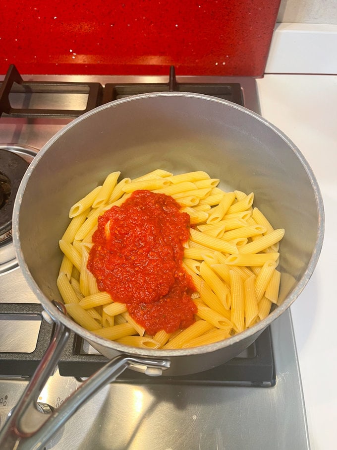 the cooked pasta with the tomato sauce added to it