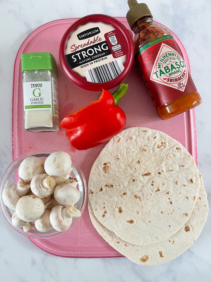 Ingredient's displayed on a pink  chopping board.