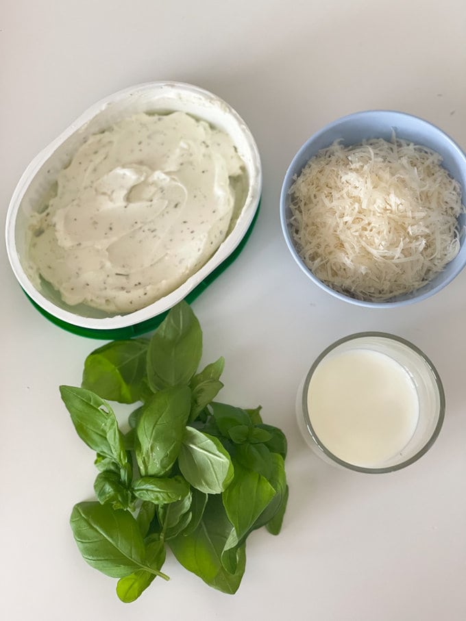 Cream cheese, grated parmesan, Basil and milk all laid out in small bowls