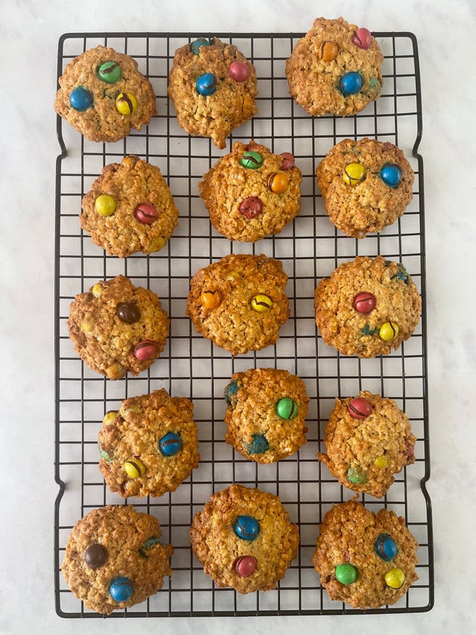 Baked M&M cookies presented on a wire cooling tray.
