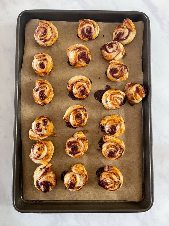 Pin wheels now out of the oven all golden and crispy on the oven tray.