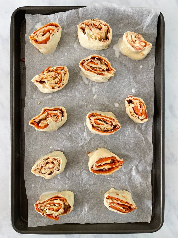 Cut into 12 slices and placed onto a greased baking tray. With milk or egg bushed on top.