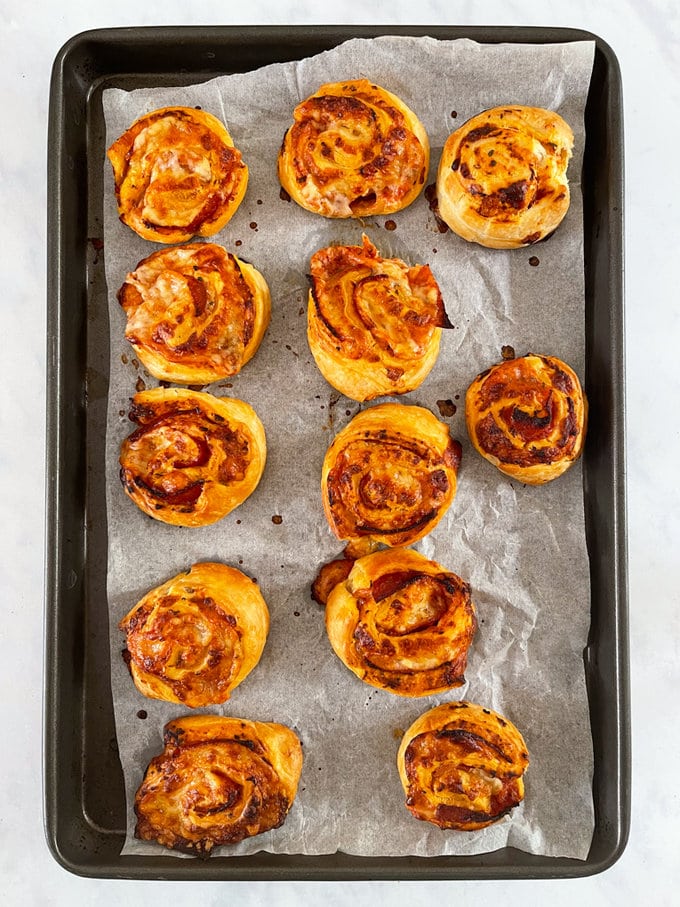 Baked pinwheels presented on a baking tray.