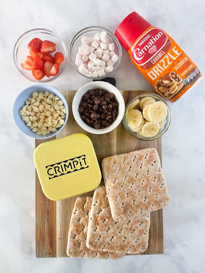 Sweet Crimpit Toastie ingredients on a wooden chopping board with a crimpit maker.