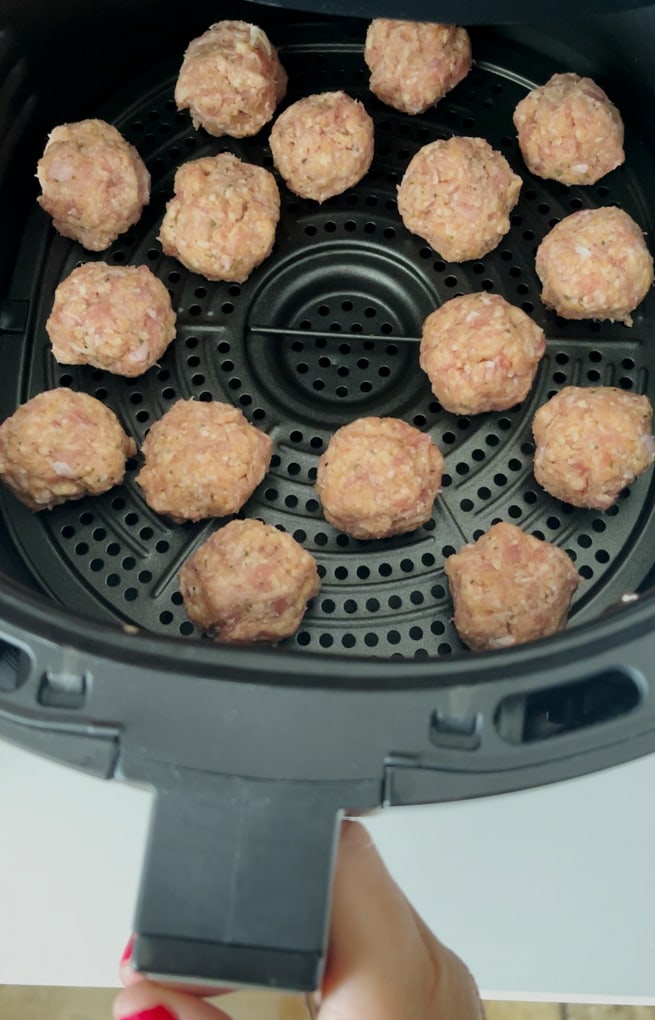 Sausage bites in the air fryer ready to be cooked.