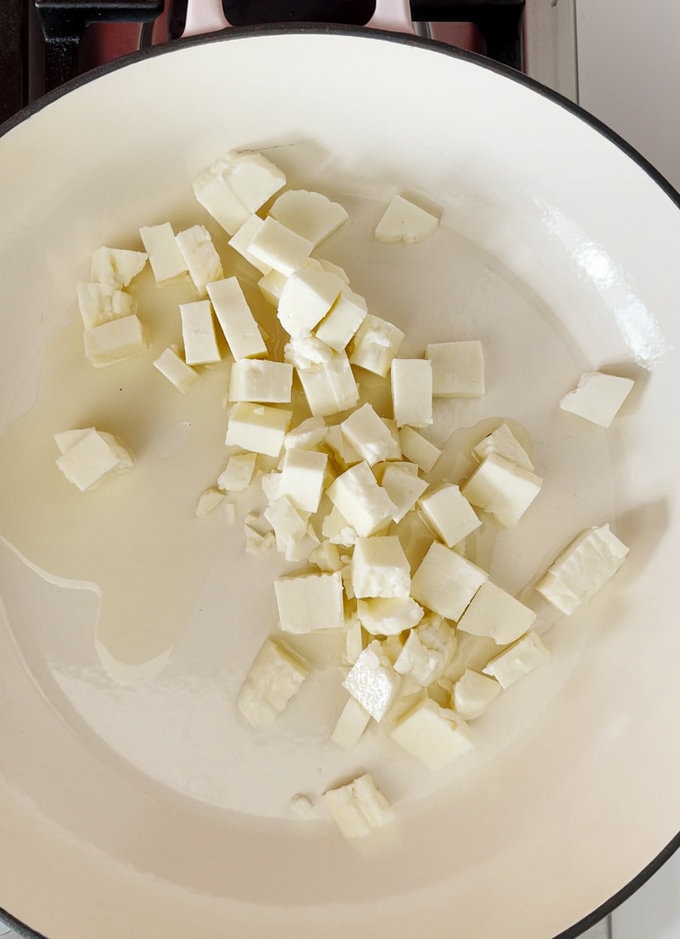 Start off by frying small cubes of halloumi in a large pot.