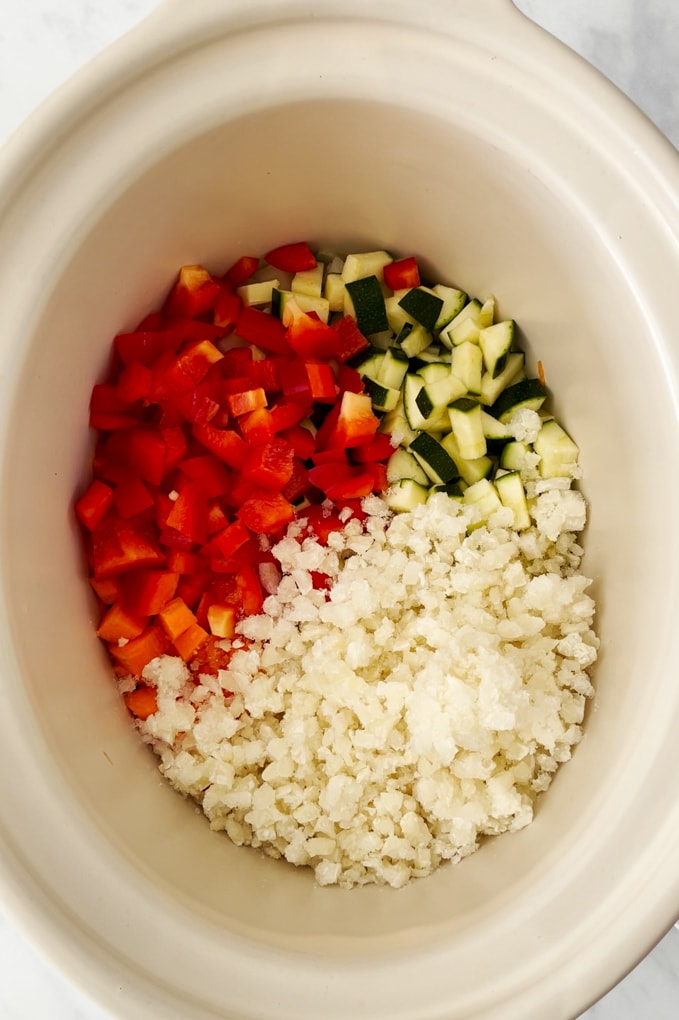 Ingredients being added to the slow cooker.