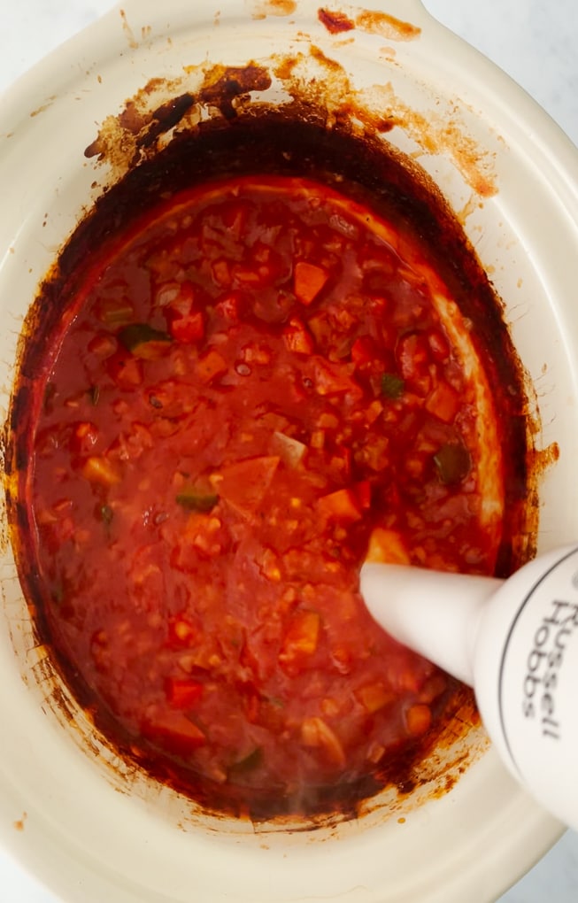 The cooked hidden veg pasta sauce being blended using a hand blender until sauce is completely smooth.  