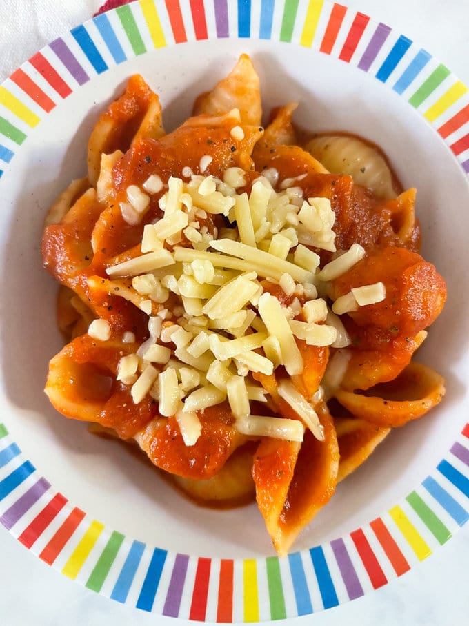 Close up of the hidden vegetable pasta sauce served with pasta and garnished with grated cheese. 
