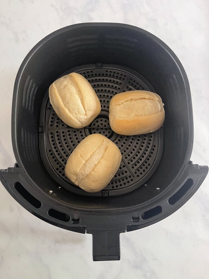Uncooked rolls sitting in the airfryer.