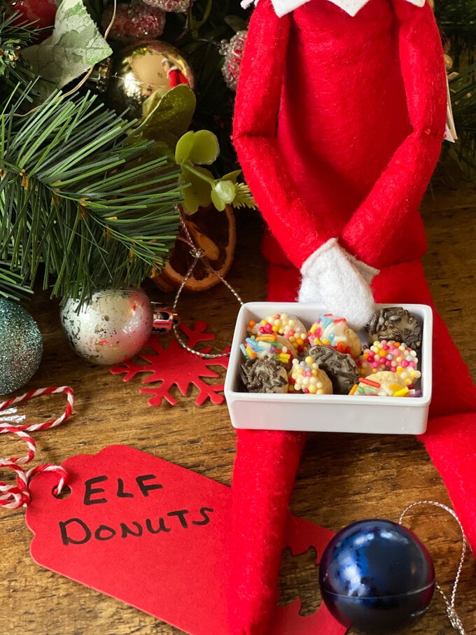 Close up of Elf donuts sitting on the Elfs lap.