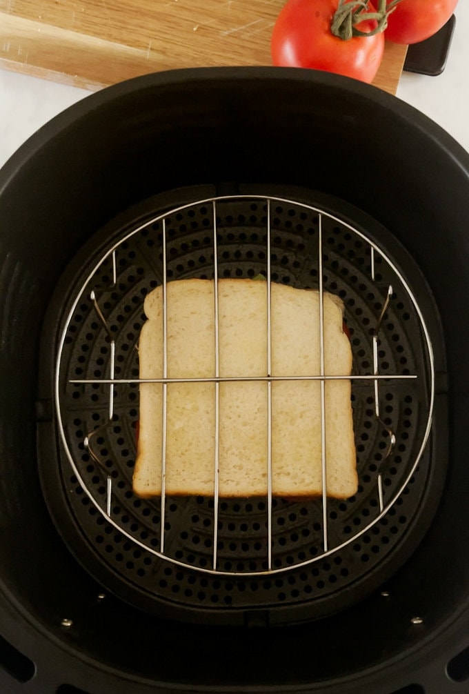 Garlic cheese and tomato toastie placed in the air fryer.