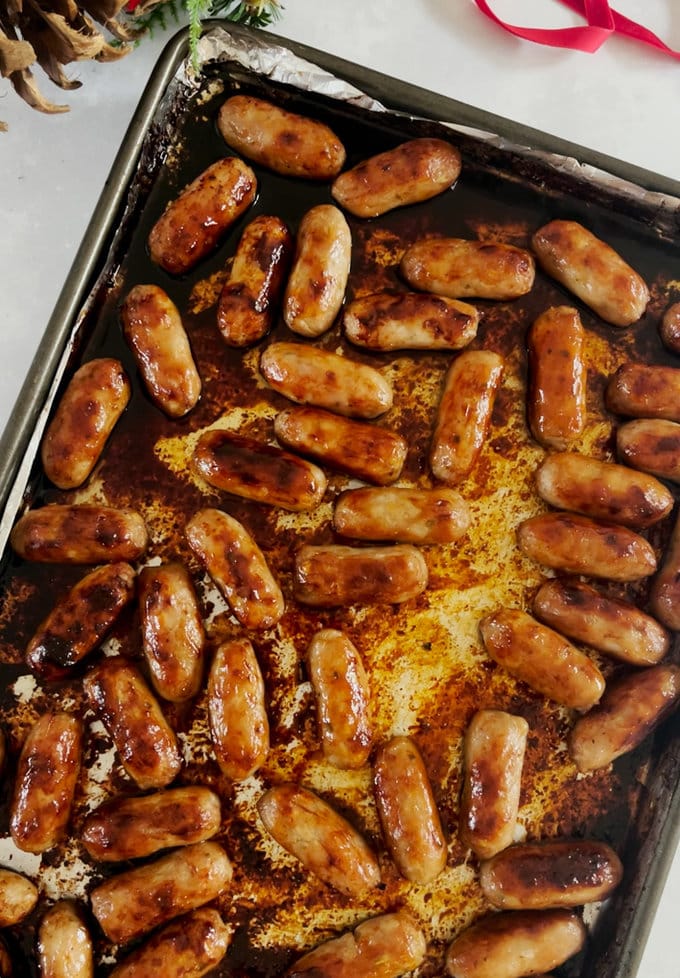 the sausages after being cooked on the baking tray
