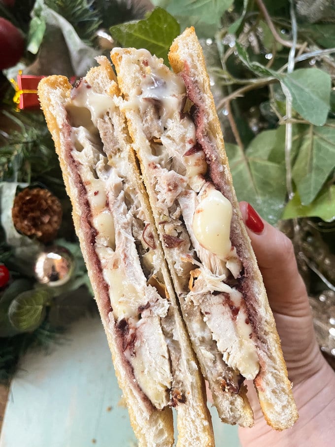 Christmas leftovers turkey toastie cut in half to show all the fillings