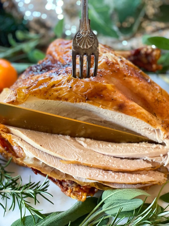 Air fryer turkey crown being sliced with a knife.