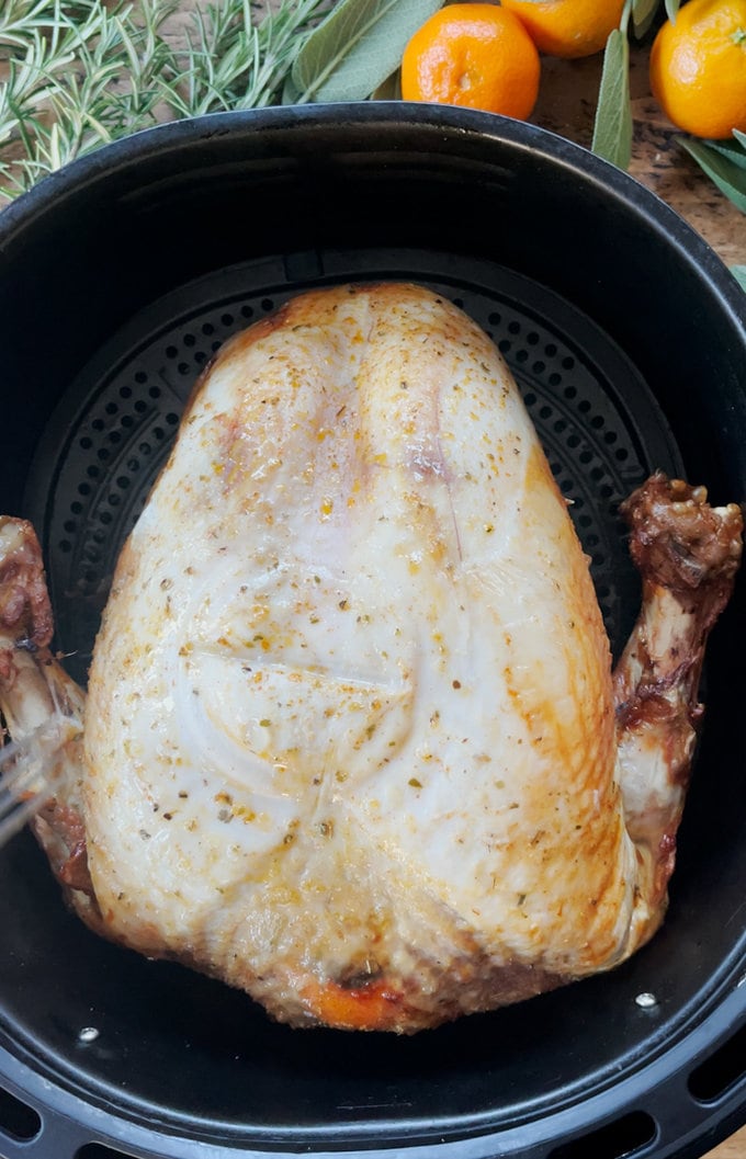 Prepped turkey crown sitting in the air fryer ready to be cooked.