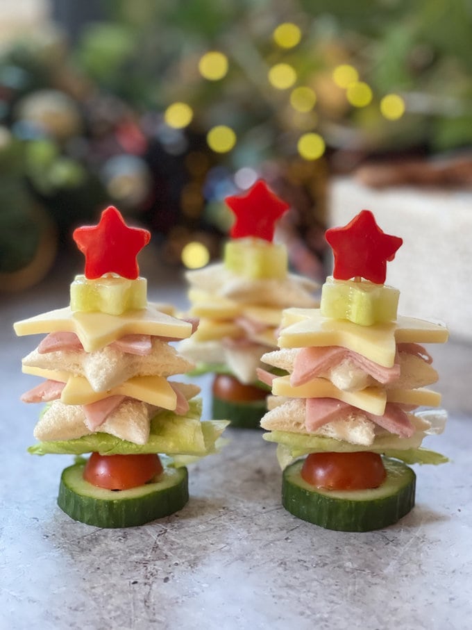 Three Christmas tree sandwiches standing up right.  
