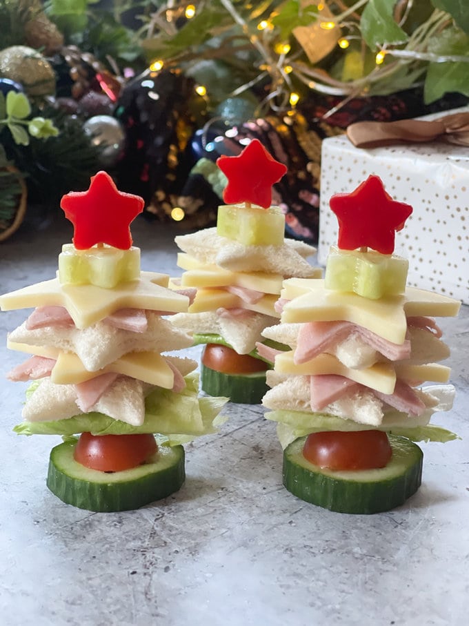 Three Christmas sandwich trees standing in a row, looking very bright and colourful.